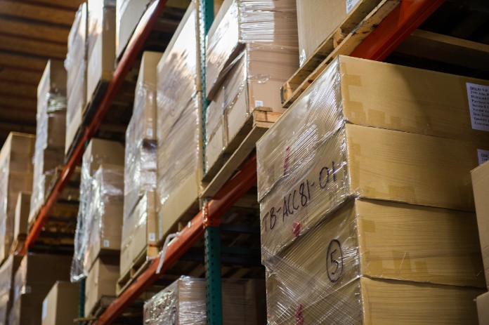 Packages stacked on shelves in a warehouse